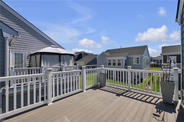 wooden deck featuring a gazebo and a residential view