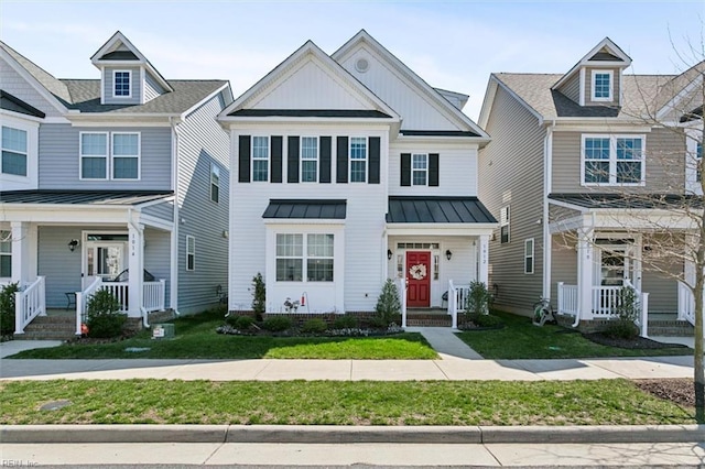 1012 Chartwell Dr, Newport News, VA 23608 - townhome / multi-family property with metal roof, a front yard, a porch, and a standing seam roof