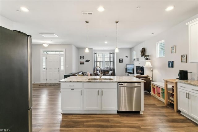 1012 Chartwell Dr, Newport News, VA 23608 - kitchen featuring open floor plan, stainless steel appliances, a sink, visible vents, and white cabinets