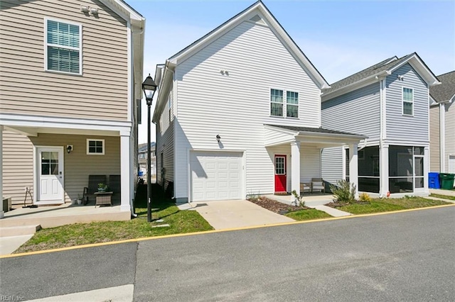 1012 Chartwell Dr, Newport News, VA 23608 - view of front of home featuring an attached garage, a sunroom, concrete driveway, and covered porch