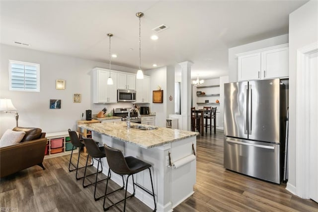 1012 Chartwell Dr, Newport News, VA 23608 - kitchen with a kitchen bar, dark wood finished floors, a sink, white cabinets, and appliances with stainless steel finishes