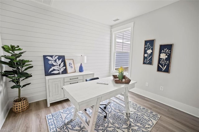 home office featuring baseboards, dark wood-style floors, and visible vents