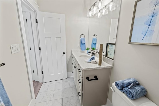 bathroom featuring marble finish floor and vanity
