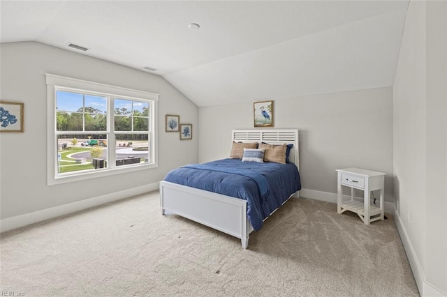 carpeted bedroom featuring baseboards, vaulted ceiling, and visible vents