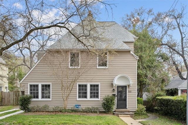 view of front of house with a front yard and fence