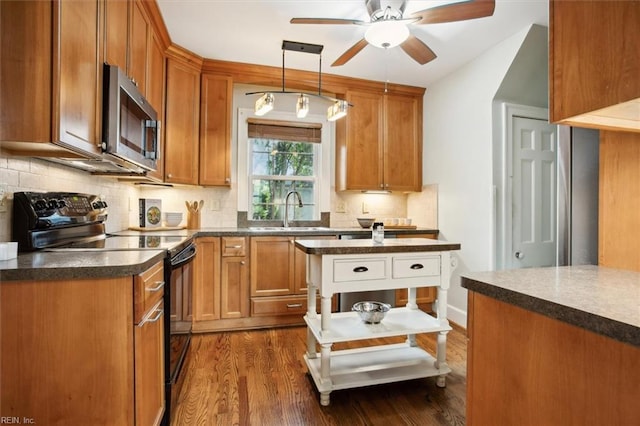 kitchen with tasteful backsplash, stainless steel microwave, a sink, ceiling fan, and black electric range