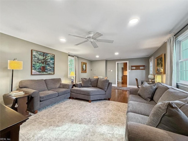 living area featuring baseboards, ceiling fan, wood finished floors, and recessed lighting