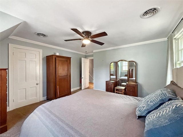 carpeted bedroom featuring ornamental molding, visible vents, and multiple windows