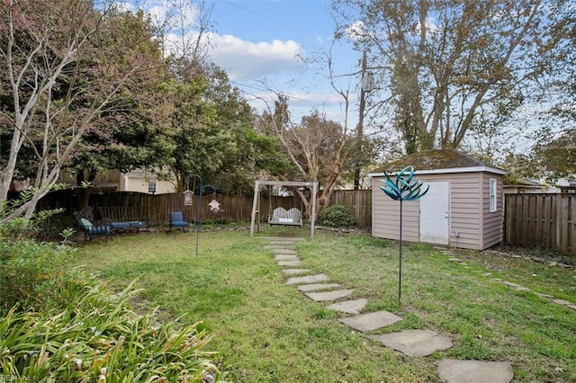 view of yard with a fenced backyard, an outdoor structure, and a storage shed