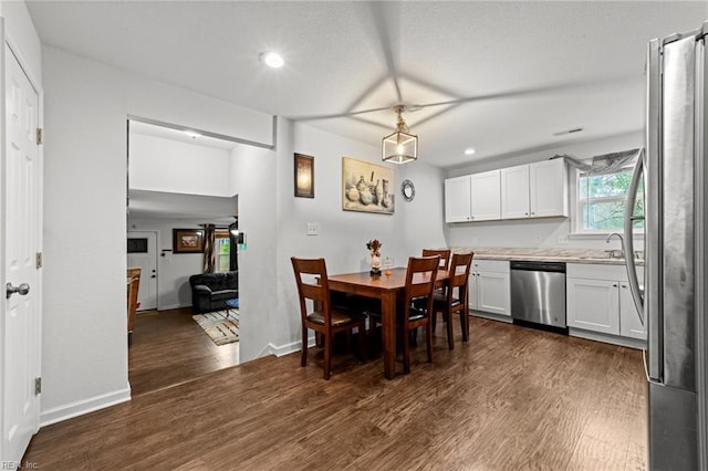 dining room featuring recessed lighting, baseboards, and dark wood finished floors