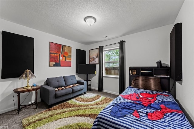 carpeted bedroom featuring baseboards and a textured ceiling