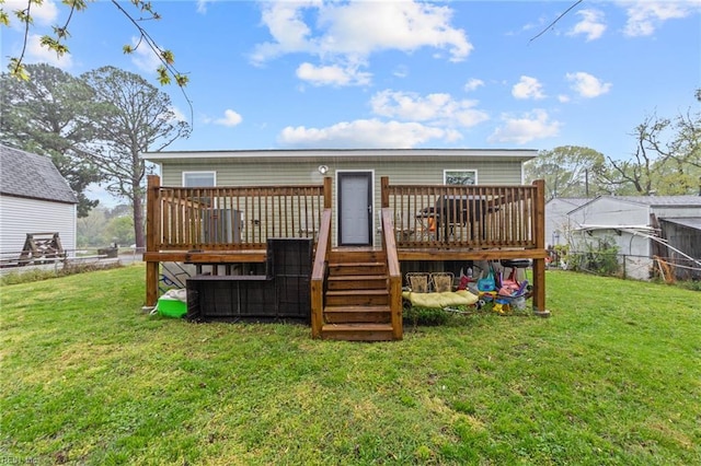 rear view of property featuring a yard, a deck, and fence