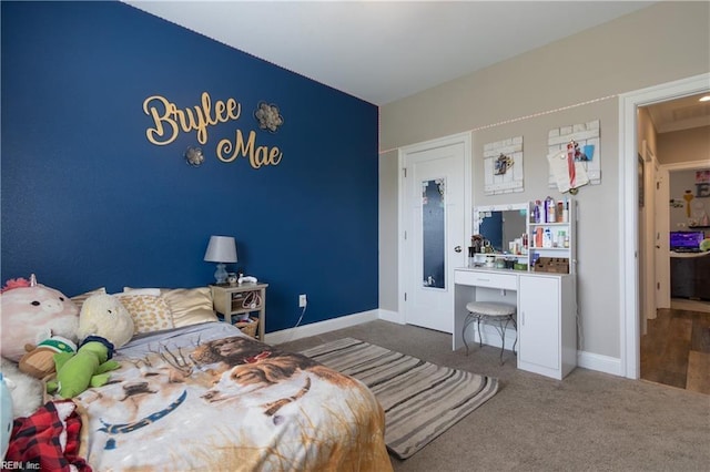 bedroom with baseboards and carpet floors