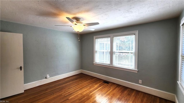 unfurnished room featuring baseboards, a textured ceiling, hardwood / wood-style flooring, and a ceiling fan