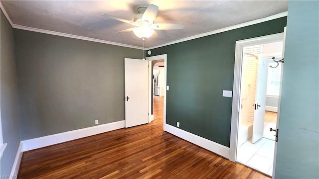 unfurnished bedroom featuring baseboards, ornamental molding, and wood finished floors
