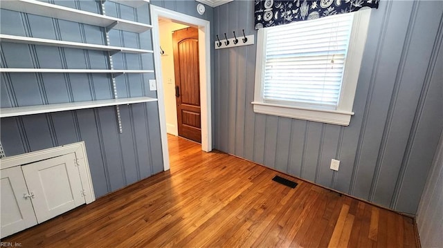 unfurnished dining area with visible vents and hardwood / wood-style floors