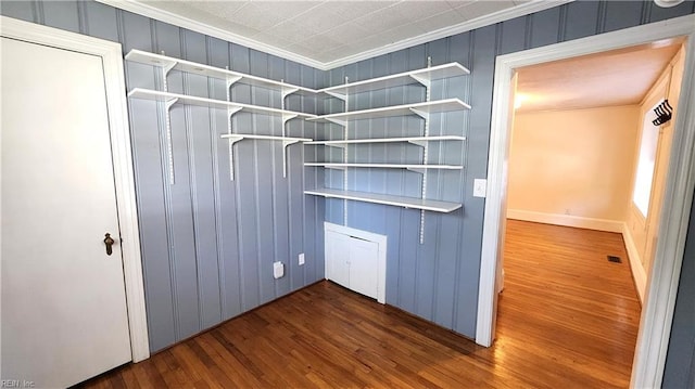 spacious closet with dark wood-style flooring and visible vents