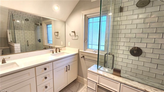 bathroom with a shower stall, marble finish floor, a sink, and vaulted ceiling