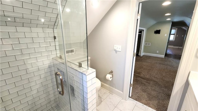 bathroom with vaulted ceiling, toilet, baseboards, a shower stall, and marble finish floor