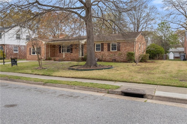 111 Garrett Dr, Hampton, VA 23669 - view of front of home featuring brick siding, a front yard, fence, and a chimney