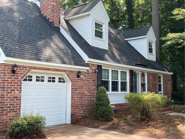 418 Pin Oak Rd, Newport News, VA 23601 - view of home's exterior featuring a chimney, a shingled roof, a garage, and brick siding