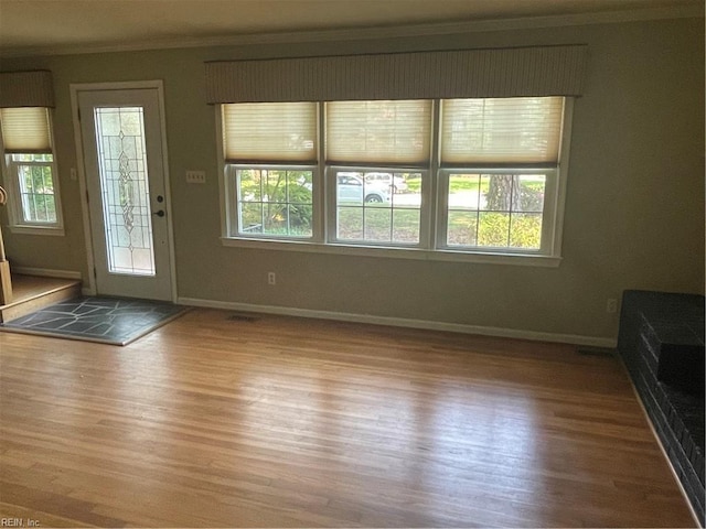 418 Pin Oak Rd, Newport News, VA 23601 - unfurnished living room with baseboards, wood finished floors, and crown molding