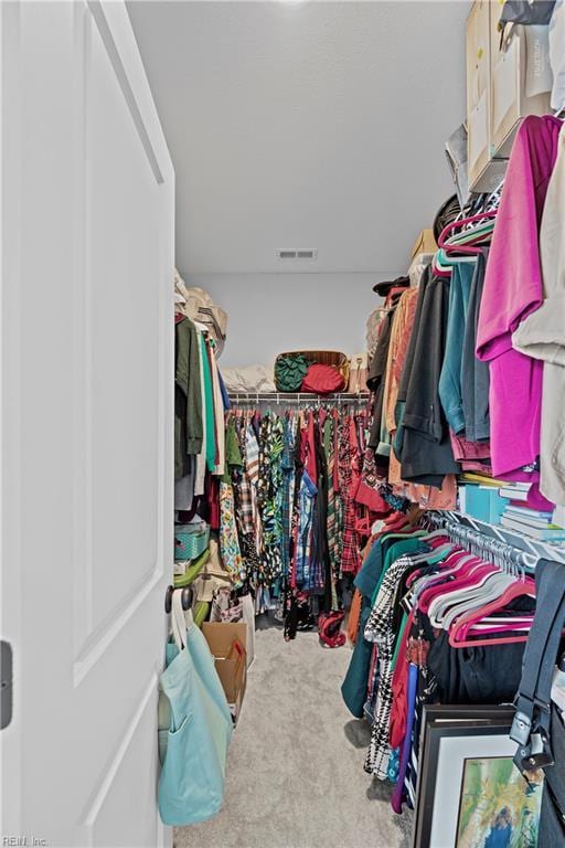 walk in closet with carpet floors and visible vents