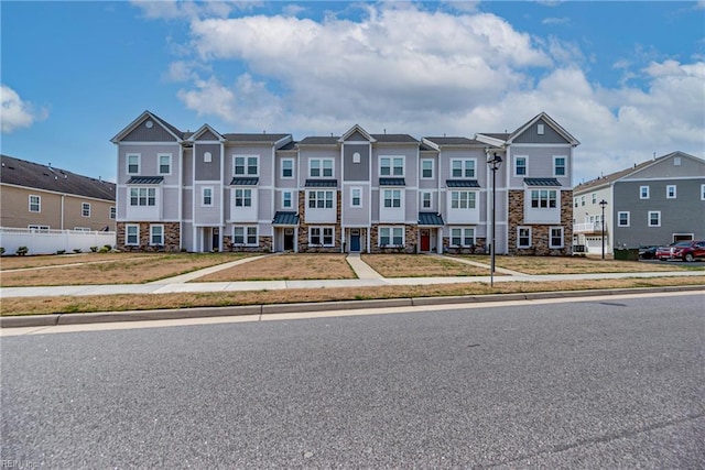 townhome / multi-family property featuring stone siding and a residential view