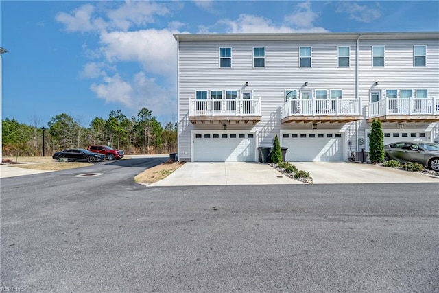 townhome / multi-family property featuring a garage and concrete driveway