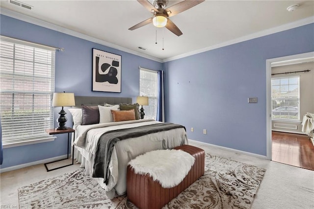 carpeted bedroom featuring crown molding, baseboards, and visible vents