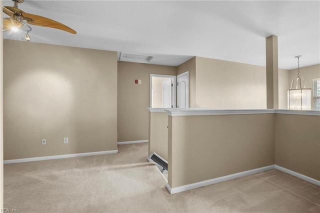 spare room featuring carpet floors, baseboards, visible vents, and ceiling fan