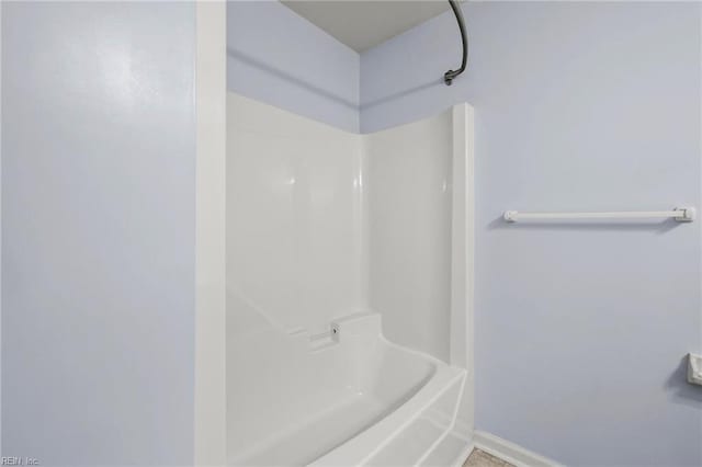 full bathroom with shower / bathtub combination and baseboards