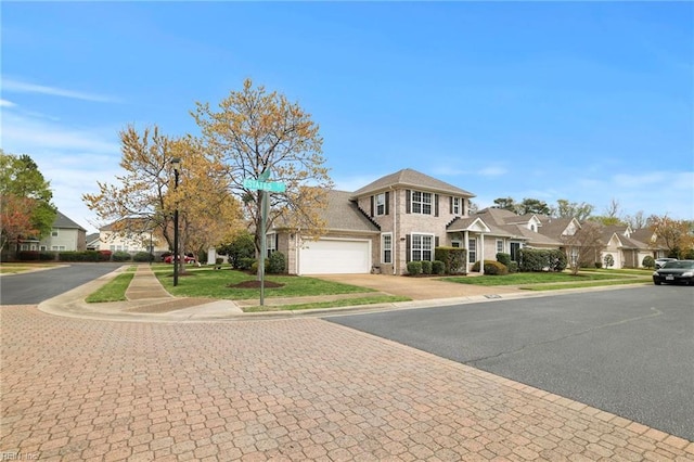 view of front of property featuring a residential view, driveway, and an attached garage