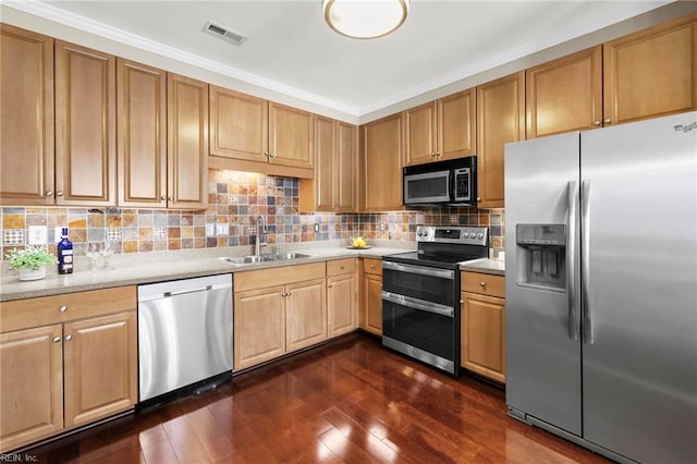 kitchen featuring light countertops, visible vents, stainless steel appliances, a sink, and dark wood-style floors