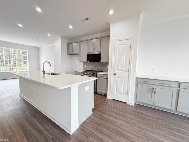 1396 Independence Blvd, Newport News, VA 23608 - kitchen with gray cabinets, crown molding, stainless steel microwave, dark wood-style flooring, and tasteful backsplash