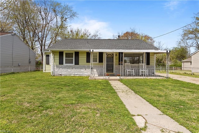 1917 Kensington Dr, Hampton, VA 23663 - view of front of house featuring stone siding, a shingled roof, fence, and a front yard