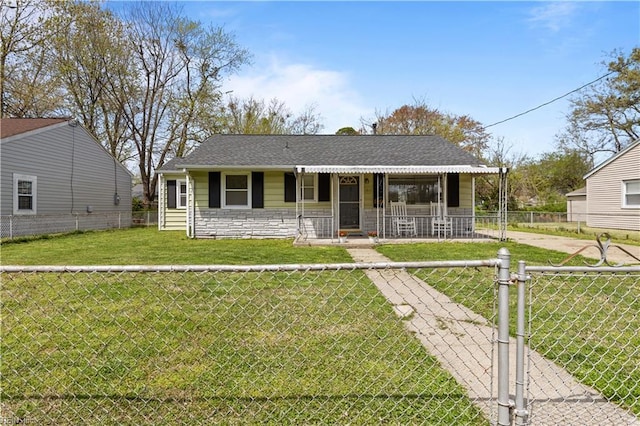 1917 Kensington Dr, Hampton, VA 23663 - view of front facade with a gate, stone siding, concrete driveway, a front lawn, and a fenced front yard