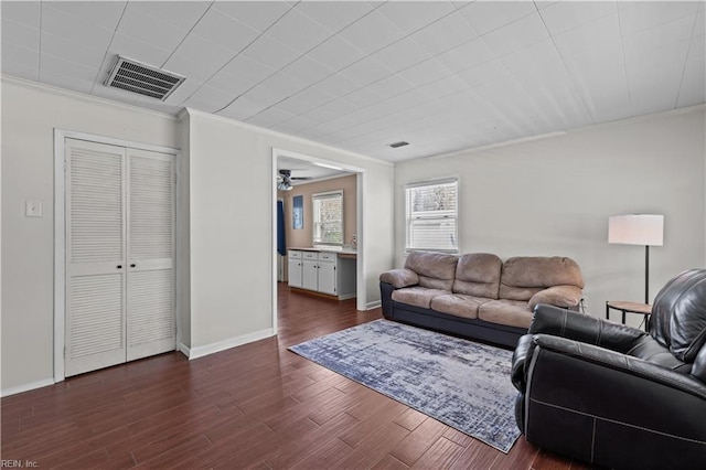 1917 Kensington Dr, Hampton, VA 23663 - living area with dark wood-type flooring, baseboards, visible vents, ceiling fan, and ornamental molding