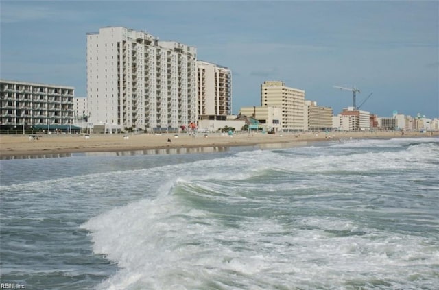 view of water feature with a beach view and a view of city