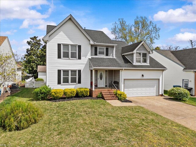 traditional home with a front yard, fence, an attached garage, a shingled roof, and concrete driveway
