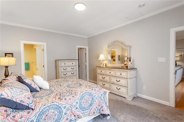bedroom with baseboards, ensuite bath, crown molding, and light carpet