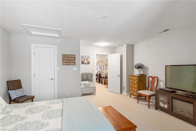 bedroom with attic access, visible vents, and carpet floors