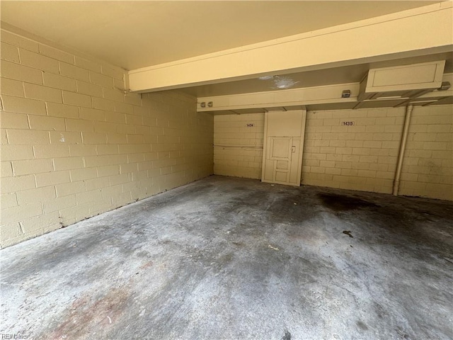 garage with concrete block wall