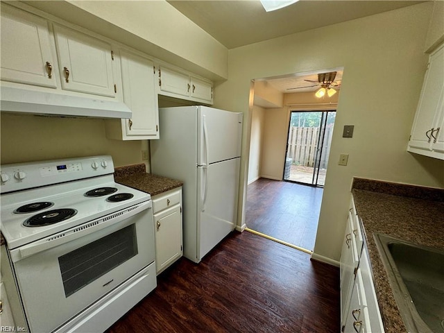 kitchen with a sink, under cabinet range hood, white appliances, dark countertops, and white cabinets
