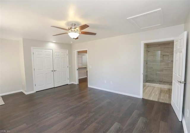 unfurnished bedroom featuring dark wood-style floors, baseboards, and attic access