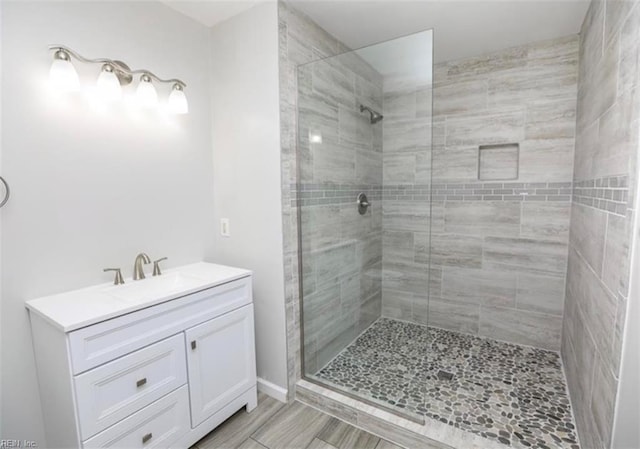 full bathroom featuring a stall shower and vanity