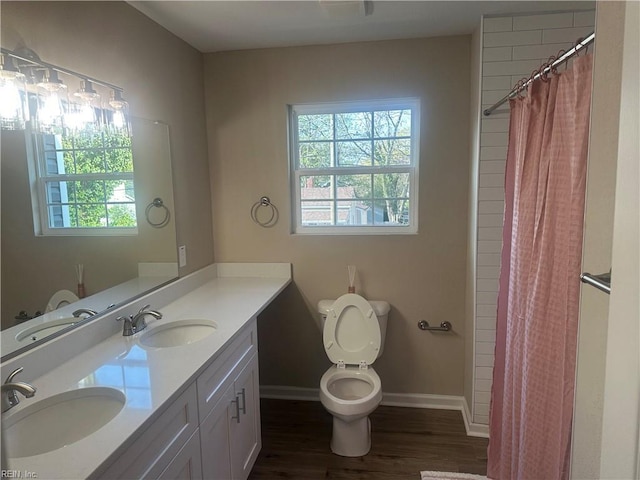 full bathroom with baseboards, wood finished floors, and a sink
