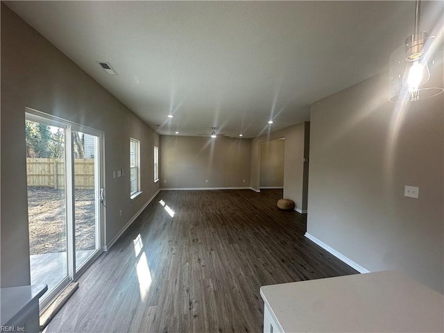 interior space featuring baseboards, visible vents, recessed lighting, and dark wood-type flooring