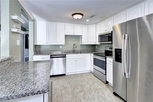 1413 Seward Dr, Hampton, VA 23663 - kitchen featuring white cabinetry, a sink, stainless steel appliances, and dark stone counters