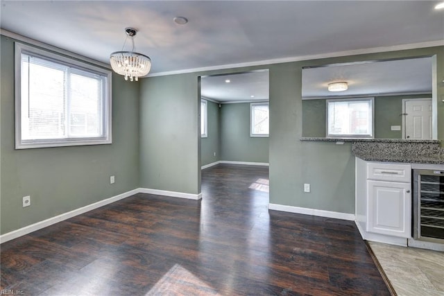1413 Seward Dr, Hampton, VA 23663 - interior space with crown molding, baseboards, wood finished floors, beverage cooler, and an inviting chandelier
